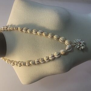 Hawaiian seashell necklace with floral pendant made of shells cowrie